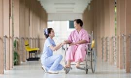 nurse caring for patient in a wheelchair