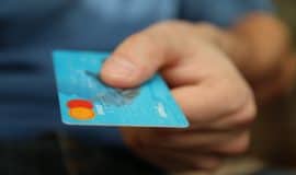 person holding out credit card