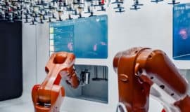 2 red robot workers in a room