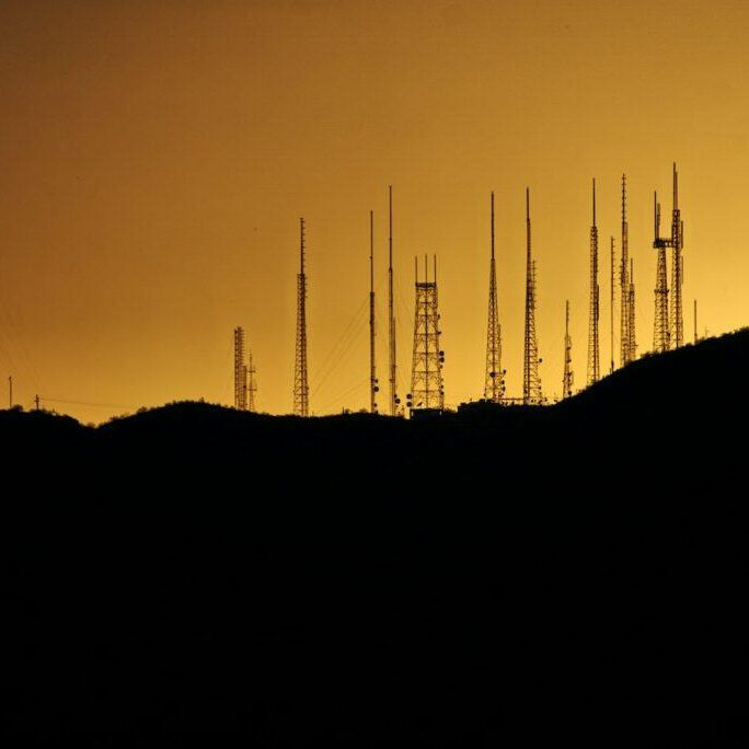 Silhouette Photo of Transmission Tower on Hill